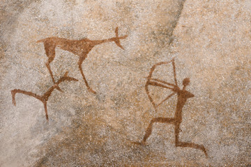 Wall Mural - a drawing of an ancient hunt on the wall of a cave of ocher. history. archeology.