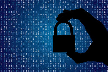 Silhouette of a hand holding a padlock with binary digital code. Security and privacy.