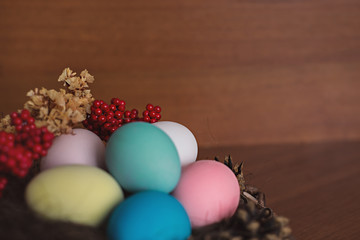 Easter eggs in the nest with red berries