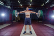 © satyrenko - Muscular fitness man preparing to deadlift a barbell over his head in modern fitness center.Functional training.Snatch exercise.