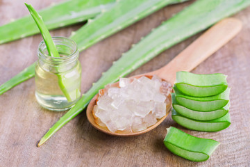 Wall Mural - fresh aloe vera leaf with sliced and gel product on wood