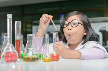 Wall Mural - excited girl making experiment with test tube