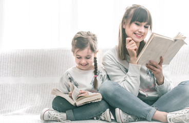 Wall Mural - Mom and daughter reading a book