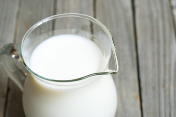 Milk jug on old wooden table