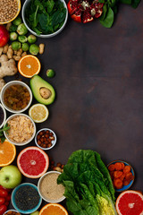 Poster - Top view set clean eating. Vegetarian healthy food - different vegetables and fruits, superfood, seeds, cereal, leaf vegetable on dark background with border. Flat lay