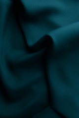 Elegant blue satin silk with waves, abstract background.