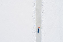 Man Ice-skating Of Frozen Lake. Aerial View