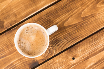 Wall Mural - coffee cup on a wooden background