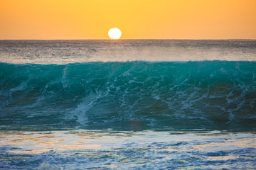 Wall Mural - sunset background, big surfing ocean wave front view, tropical sea water