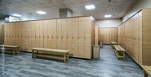 Wooden Lockers With A Wood Bench In A Locker Room With Doors