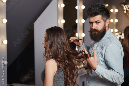 Cute Male Hairdresser Makes Haircut A Young Woman In A Beauty