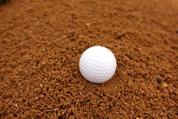 Golf ball in a sand bunker