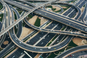 aerial view of big highway interchange with traffic in dubai, uae, at day. scenic cityscape. colorfu