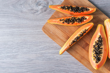 Papaya on wooden background. Healthy food, ripe exotic fruits. The concept of vegetarianism