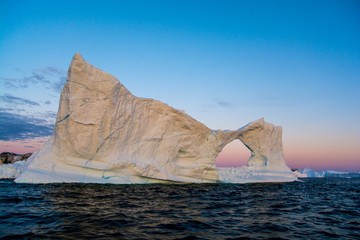Wall Mural - iceberg in sunrise. soft light of white nights in greenland