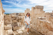 Young attractive tourist girl walks through the archaeological park during summer holidays, travel  to Cyprus, ancient ruins, history