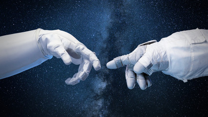 Wall Mural - two near touching hands in space suits, 'god touches adam' pose