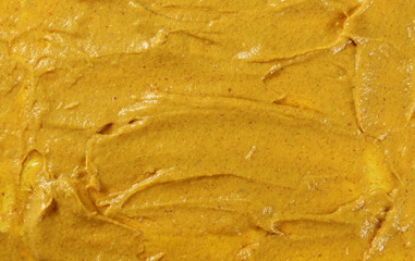 Yellow mustard sauce, spread background and texture, top view