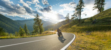 Motorcycle Driver Riding In Alpine Highway, Nockalmstrasse, Austria, Europe.