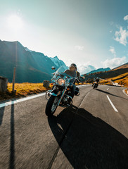 Wall Mural - Motorcycle driver riding japanese high power cruiser in Alpine highway on famous Hochalpenstrasse, Austria.