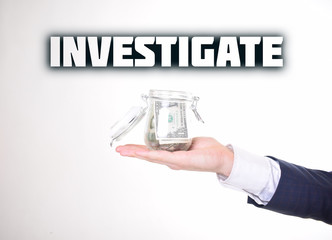 A businessman with a bank of money shows an inscription:INVESTIGATE