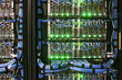 © Mint Images - Servers with CAT 5 cables on racks  in a large computer server farm.