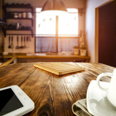 Wall Mural - a telephone and a cup and a chopping board on a wooden kitchen table with copy space for products ag