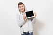 © ViDi Studio - Young handsome smiling man in t-shirt and light sweatshirt with hood with headphones holds tablet pc computer with blank screen for copy space isolated on white background. Concept of technology.