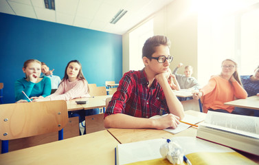 Poster - education, bullying, conflict, social relations and people concept - student boy in glasses reading book and suffering of classmates mockery at school