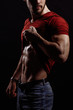 © alfa27 - closeup cropped image of young sexy male in red T-shirt and jeans doing a striptease.taking off T-shirt.naked torso.press. man's coquety.flirtation. demonstrating body