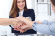 © rogerphoto - Close Up of unknown business people joining hands. Teamwork, cooperation and success concept of people communication