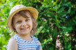 © Ekaterina Senyutina - A smiling or laughing little girl in a straw hat, summertime vacation