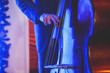 Concert view of a contrabass violoncello player with vocalist and musical during jazz band performing