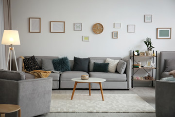 Poster - Modern living room interior with comfortable sofa and small table