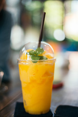 Orange juice smoothie glass on wood table