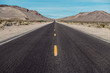 © Nick Starichenko - Empty scenic long straight desert road with yellow marking lines