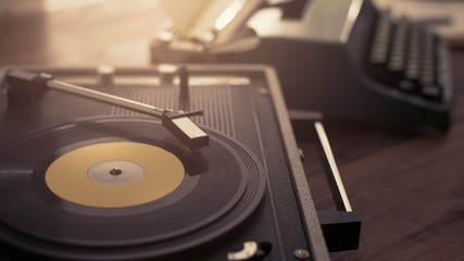 Record player and vintage typewriter on a desk, creativity and leisure concept