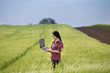 © Budimir Jevtic - Farmer girl with laptop in field