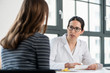 © Kzenon - Female physician listening to her patient during consultation while sitting down in the office of a modern medical center