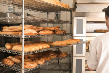 Wall Mural - Shelves with delicious fresh bread in bakery