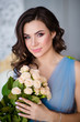 © Татьяна Бердо - beautiful girl with dark hair with flowers in her hands in a blue dress