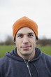 © Mint Images - Portrait of a Caucasian man in an orange beanie hat.
