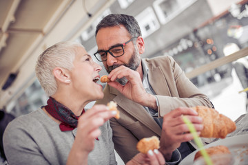 Wall Mural - Beautiful mature couple having breakfast in cafe