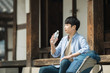 © Dialogue Frame - A young man traveling to Korea is taking a rest with a water bottle.