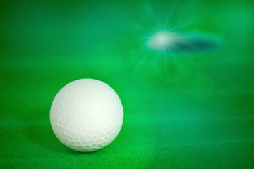  Golf ball / View of old golf ball on green artificial grass background.