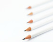 Pencils against a white background with a shallow depth of field.