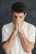 © Prostock-studio - Portrait of hopeful man praying,