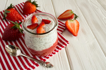 Wall Mural - Pudding with chia and strawberry on the striped napkin