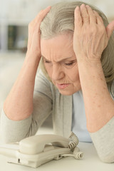 Wall Mural - upset senior woman with  phone