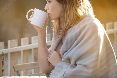 Fotografija Woman drinking coffee in chilly morning and enjoying beautiful sunny day